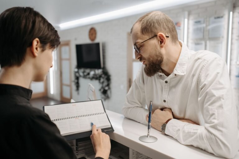Dental patient reviewing implant financing paperwork with staff
