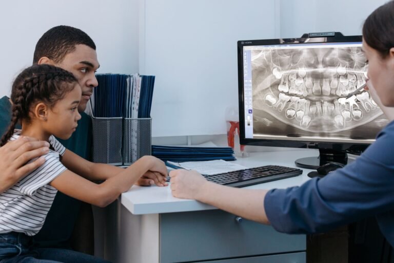 Dentist reviewing dental X-ray with a young patient