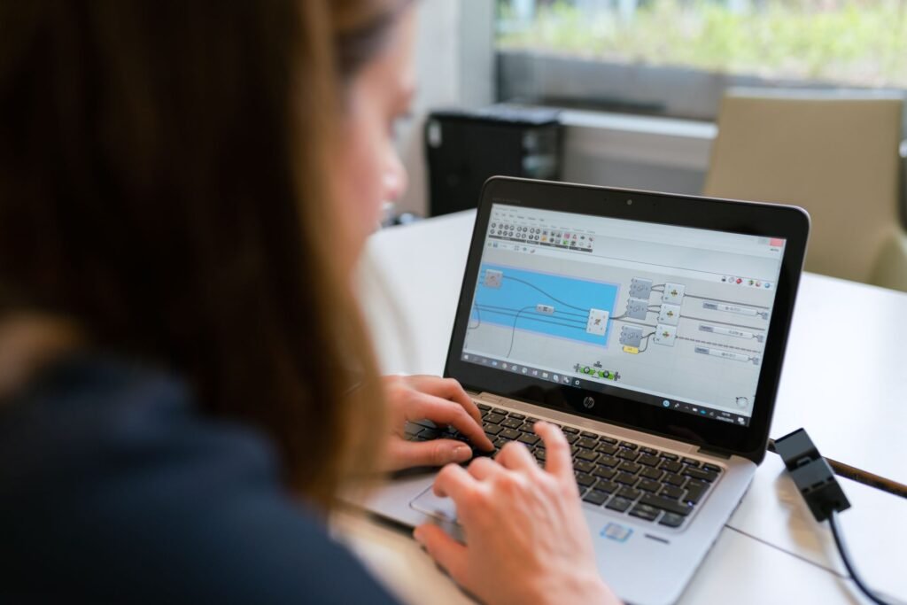 Dental office manager reviewing automation software on a laptop