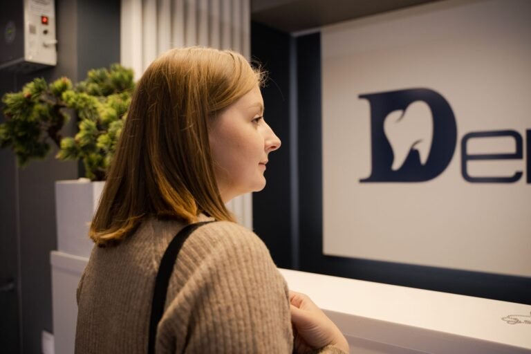 Dental practice front desk discussing insurance and payment options with a patient