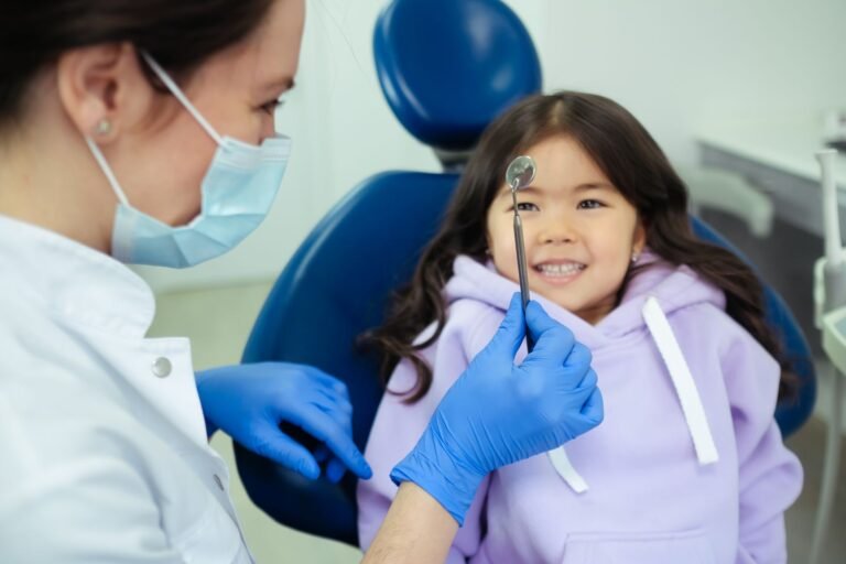 Pediatric dentist making a young patient comfortable in a Florida dental office