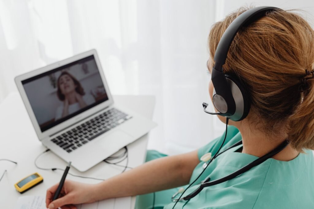 Dentist conducting a virtual teledentistry consultation on a laptop