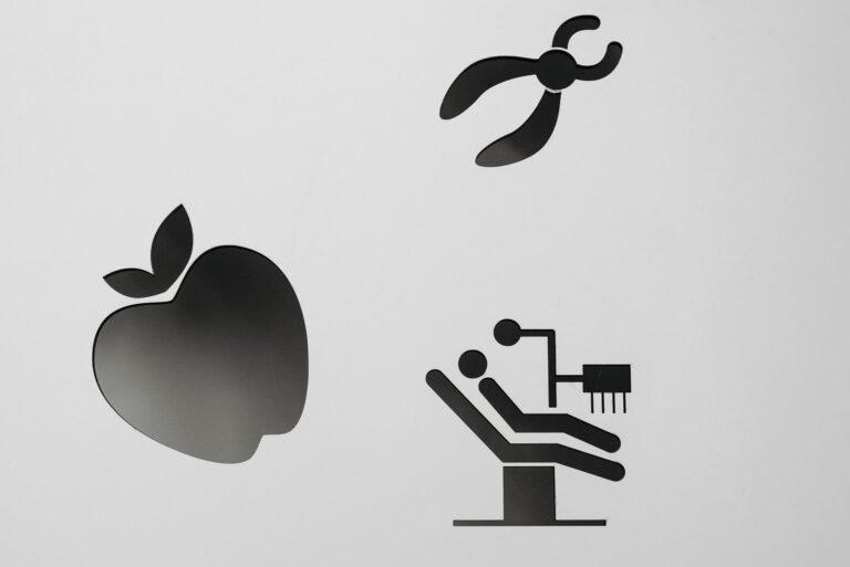 Dental practice logo and branding materials on a desk