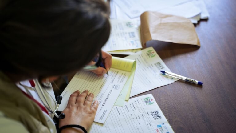 Physical therapist handing discharge paperwork to a patient